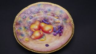 A. G. Delaney porcelain gilded plate, decorated with hand painted fruit by Delaney. D.27cm