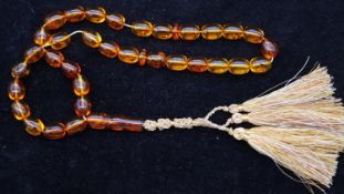 A string of thirty six baltic amber prayer beads, thirty two beads contain insect inclusions. Weight