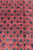 A modern rug with all over repeating diamond pattern on a rouge ground. L.190 W.125cm