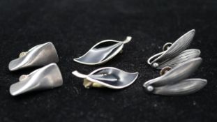 Three pairs of Danish silver clip earrings. One pair of black enamel Norwegian leaf earrings by
