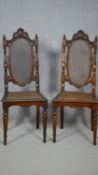 A pair of carved Carolean style side chairs with caned backs and seats on turned stretchered