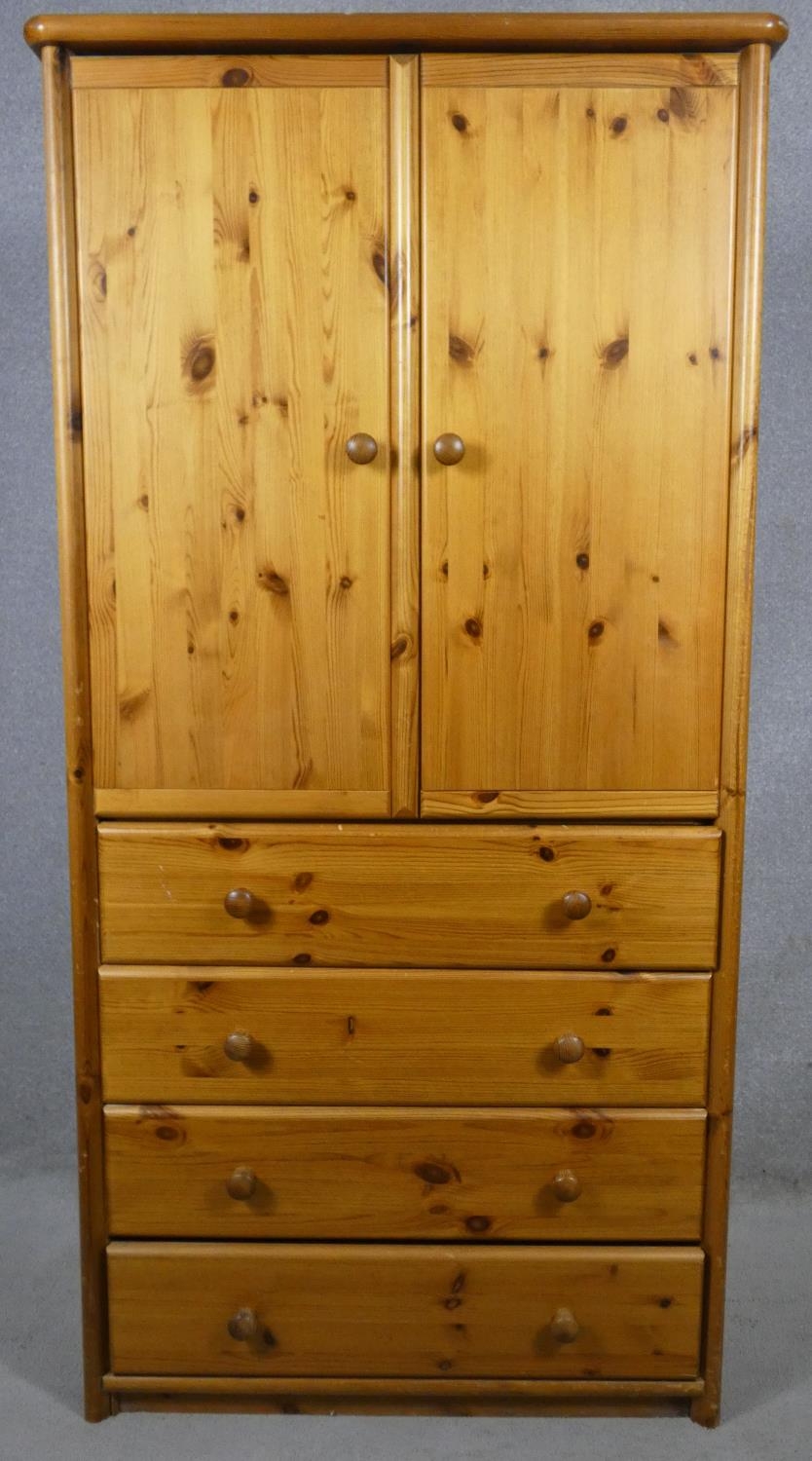 A contemporary pine wardrobe with hanging section above drawers. H.180 W.90 D.54cm