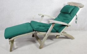A contemporary weathered teak steamer deck chair by Indian Ocean with fitted cushion. H.100 W.52 L.