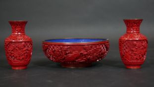 A Chinese carved cinnabar lacquer bowl with blue enamel interior and a pair of similar vases. Dia.