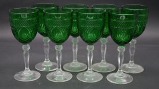 A set of eight vintage emerald moulded glass wine goblets on clear glass stems. H.20.5cm