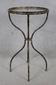 A shaped wrought metal conservatory occasional table with inset plate glass top. H.80cm