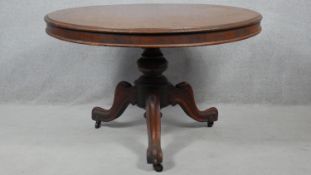 A Victorian mahogany tilt top dining table on carved pedestal tripod cabriole base. H.77 D.117.5cm