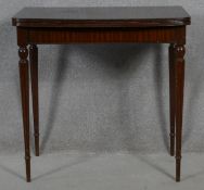 A 19th century style mahogany foldover top card table on fluted tapering supports. H.70.5 L.89 W.