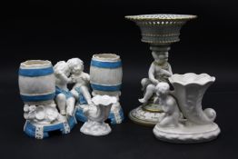 A 19th century Mintons tazza with a seated cherub support, A Royal Worcester cornucopia epergne vase