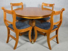 A Regency style yew wood dining table and matching bar back dining chairs. Table H.77 W.107cm Chairs