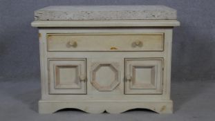 A Continental painted side cabinet with sandstone slab top on shaped bracket feet. H.67 W.91 D.61cm