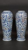 A pair of Chinese Ming style vases with phoenix and flowers and blue white and copper red glaze