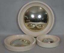 A set of three white framed Regency style convex wall mirrors. D.50cm (Largest)