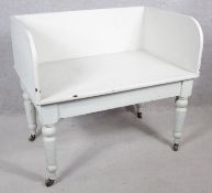 A 19th century white painted hall seat on turned tapering supports. H.80 W.90 D.60cm