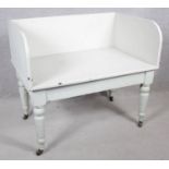 A 19th century white painted hall seat on turned tapering supports. H.80 W.90 D.60cm