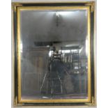A large wall mirror with bevelled plate in ebonised and gilt floral frame. H.140 W.110cm