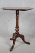 A late 19th century occasional table, the moulded shaped top with paterae central inlay on tripod