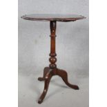 A late 19th century occasional table, the moulded shaped top with paterae central inlay on tripod