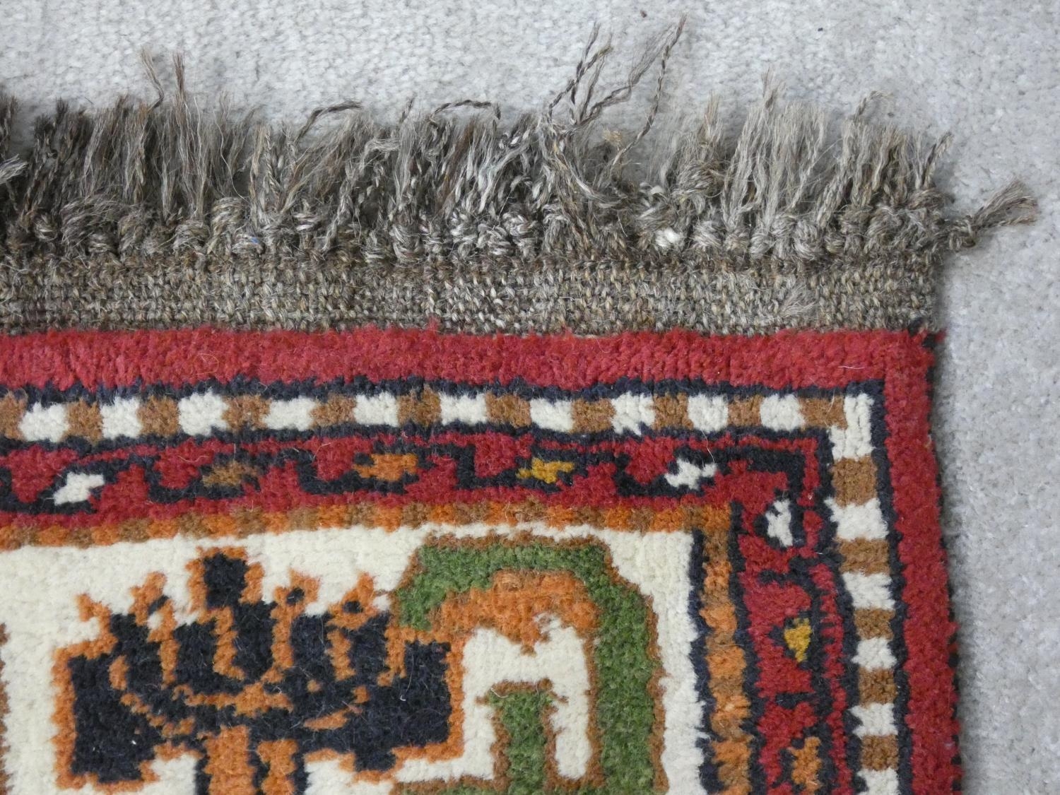 A Turkish Kars rug with repeating medallions on madder ground within spandrels and stylised lotus - Image 3 of 3