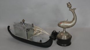 An embossed metal table lamp in the form of a leaping fish and a vintage gondola table lamp. H.