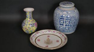 A Chinese Famille Rose armorial plate along with an Imperial yellow hand painted porcelain bottle