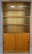 A mid century vintage teak library bookcase by Gibbs Furniture with sliding glazed doors enclosing