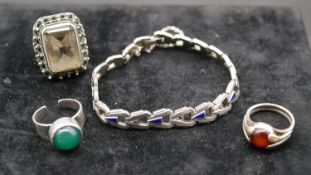 An Art Deco articulated silver and blue enamel bracelet set with marcasite along with three silver
