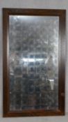 A large oak framed wall mirror with opaque antique style silvered plate. H.148 W.87cm