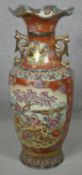 A large Oriental gilded and hand painted vase on carved wooden base with scrolling gilded handles.
