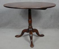 A Georgian mahogany tilt top occasional table on turned pedestal tripod base on cabriole pad foot