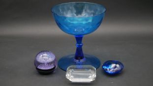 A Tiffany and Co glass paperweight, a Caithness paperweight numbered and marked Ice Fountain, a blue