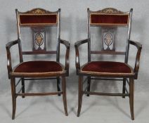 A pair of late Victorian rosewood armchairs with satinwood and ivory scrolling foliate urn inlay