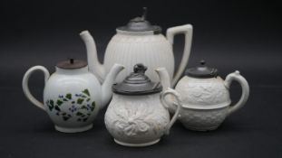 Three 19th century stoneware teapots with pewter lids and raised foliate decoration along with an