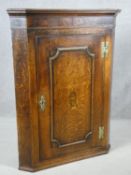 A Georgian oak corner cupboard with bird and urn satinwood inlay to the panel door. H.100 W.75 D.