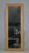 A dressing mirror in light oak frame. H.136.5 W.52.5cm