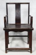 A Chinese hardwood armchair with carved roundel to the splat above panel seat on shaped