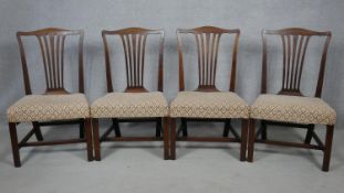 A set of four 19th century mahogany dining chairs with pierced shaped splats above stuff over