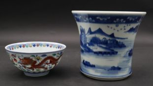 A Chinese blue and white hand painted porcelain brush pot with landscape and figures and a Qing