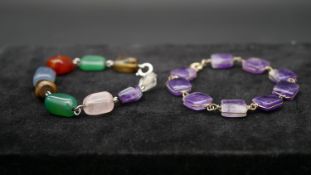 Two gemstone chain link bracelets. One with polished rectangular amethyst beads on yellow metal wire