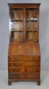 A Georgian style flame mahogany and crossbanded bureau bookcase with fitted interior. H.188 W.75 D.