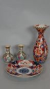 An Imari style plate and a similar vase with flared neck along with a pair of Famille Vert bulbous