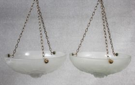 A pair of Art Deco opaque glass ceiling pendant light shades with moulded rose flowerhead