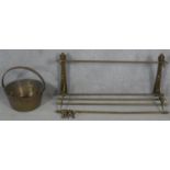 A 19th century brass wall mounted kitchen utilities rack and a heavy brass Victorian swing handled