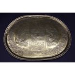 A brass serving platter embossed with the Star of David and Hebrew writings with all over