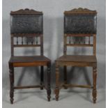 A pair of late 19th century oak hall chairs in embossed leather upholstery on turned and stretchered