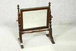 A 19th century mahogany framed swing toilet mirror on turned supports and platform base. H.43cm
