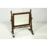 A 19th century mahogany framed swing toilet mirror on turned supports and platform base. H.43cm