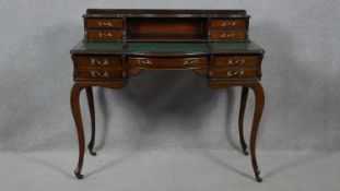 A late 19th century mahogany writing table with baize lined writing surface and slide action to