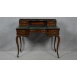 A late 19th century mahogany writing table with baize lined writing surface and slide action to