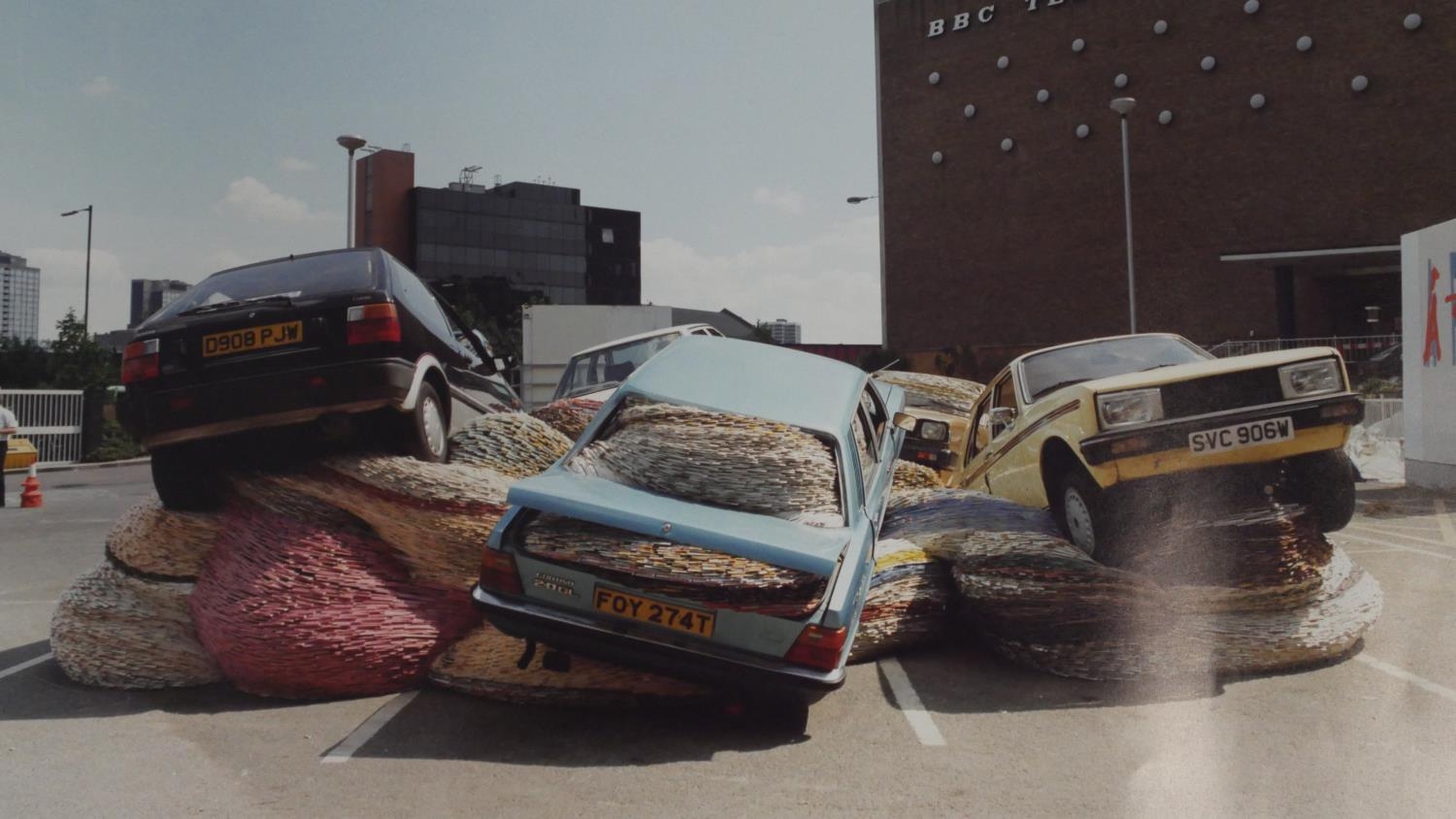 A signed coloured photo by Scottish artist David Mach of his sculpture Multi Story Car Park, May,